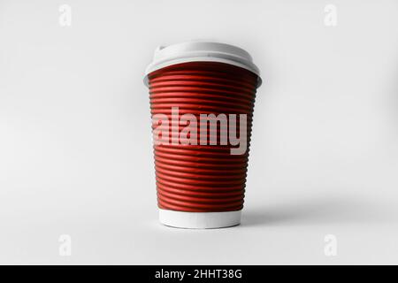 Disposable red paper cup for coffee on a gray background. Stock Photo