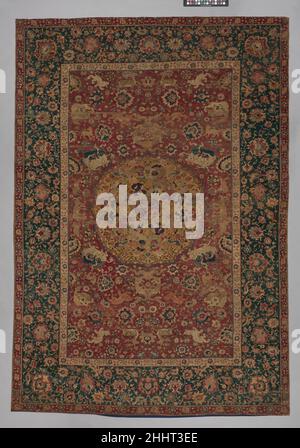 https://l450v.alamy.com/450v/2hht3ee/carpet-second-half-16th-century-the-scenes-depicted-on-this-carpet-may-allude-to-the-bazm-or-the-feast-that-followed-the-battle-in-iranian-history-and-literature-in-the-central-medallion-a-group-of-beardless-seated-men-are-drinking-talking-and-playing-music-while-four-standing-figures-hold-goats-perhaps-in-anticipation-of-the-banquet-the-vignettes-of-predators-attacking-or-stalking-prey-signify-ideas-of-dominance-thus-relating-to-the-razm-or-battle-the-figures-turbans-with-their-low-kulahs-or-caps-indicate-that-the-carpet-was-produced-after-the-early-safavid-taj-or-cap-with-a-h-2hht3ee.jpg