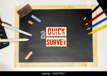 Quick Survey. Speech Bubble on a dark textured wooden background. Stock Photo