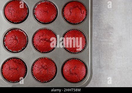 Red velvet cupcakes in baking pan on white background. Top view. Stock Photo
