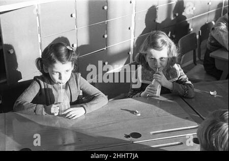 Pupils at South Mead School, Southfield, Wimbledon having their morning milk before play time.. 14th January 1954 Stock Photo