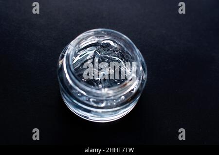 Transparent cosmetic gel for skin care with bubbles close-up on a black background Stock Photo