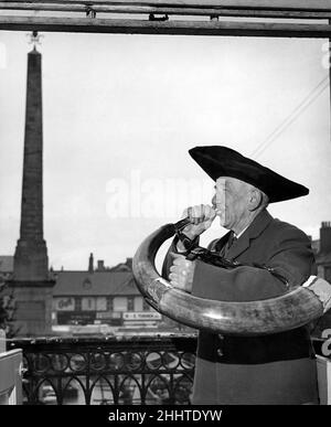 Ripon - Yorkshire. An ancient custom is the blowing of the mayors horn - three blasts at 9.p.m. every night, and at the opening of the market. Tom Horley, aged 78, is the hornblower or wakeman. He first blew it 55 years ago. His son Cyril Horley is the Sergeant at Mace to the Mayor. Photograph shows him with his father overlooking the Market Place showing the Market Cross which looks like a. January 1953 P005060The scrimmage for the barrel. Rugby tactics or football can be used. April 1944 P005044 Stock Photo