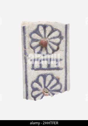 Fragment of a Handle from a Vessel ca. 1390–1353 B.C. New Kingdom This fragment of a handle once belonged to a small vessel made from faience that was glazed white. The two rosettes serving as part of the handle’s decoration are outlined in blue; one still has a red dot of faience serving as the flower’s center.Many fragments of elegantly decorated faience vessels have been found among the remains of the King’s Palace at Malqata. This important ritual building was at the heart of the festival-city built by Amenhotep III on the west bank of Thebes.. Fragment of a Handle from a Vessel. ca. 1390– Stock Photo