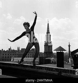 Dancer Gillian Lynne, the lead solo dancer of a new American musical Can Can which is opening at the Stoll Theatre, practising her routine on a rooftop. 7th September 1954. Stock Photo