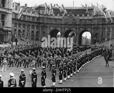 Band and Corps of Drums of the Welsh and Irish Guards part of Her Majesty Procession make their way through Admiralty Arch as they escort the Queen's coach to Westminster Abbey for her Coronation. 2nd June 1953 Stock Photo