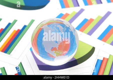 Glass globe of North and South America with graph printed documents Stock Photo