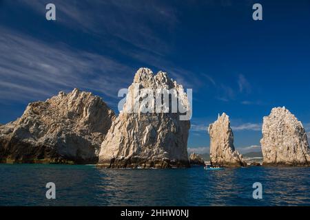 A glass bottom boat takes tourists around rock formations near the Arch in Cabo San Lucas, Baja California Sur, Mexico Stock Photo