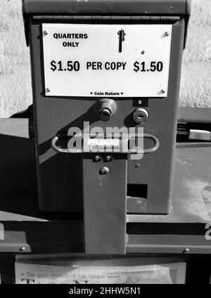 A coin-operated newspaper vending machine in Taos, New Mexico. Stock Photo