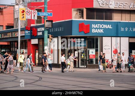Toronto, Canada - 08 19 2018: people in front of the National Bank branch on Spadina at Dundas intersection in Chinatown neigbourhood of Old Toronto Stock Photo