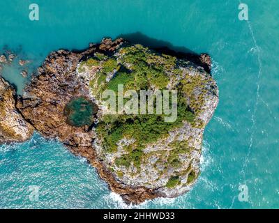 Drone view looking down onto Wedge Island Cape Hillsborough Australia rocky outcrop in the ocean offshore from tropical beach Stock Photo