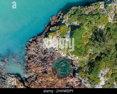 Drone view looking down onto Wedge Island Cape Hillsborough Australia with rock pool in the ocean offshore from tropical beach Stock Photo