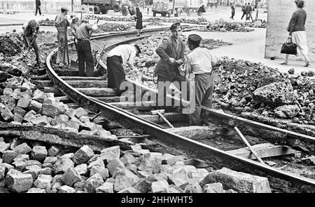 Scenes in Naples, southern Italy showing local people at work on the railway lines. Circa 1955 Stock Photo