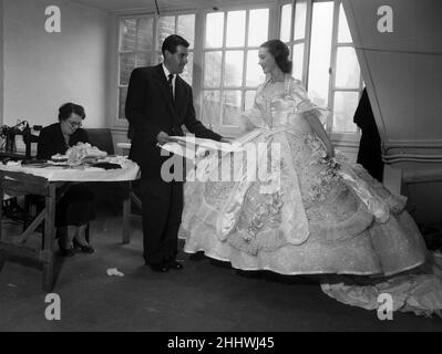 Actress Julie Andrews trying on a dress for her role in the pantomime 'Cinderella' at the Palladium. 13th November 1953. Stock Photo