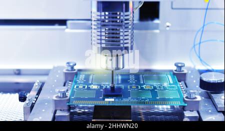 High technology and modern automatic robot for print circuit board (PCB)assembly machine during soldering or welding part or component at factory Stock Photo