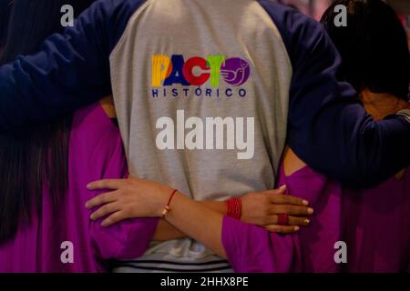 Bogota, Colombia. 25th Jan, 2022. A supporter of political alliance 'Pacto Historico' wears a shirt of the alliance party while hugging other supporters in downtown Bogota at the door of the Jorge Eliecer Gaitan Theatre in Bogota, Colombia on January 25, 2022. Credit: Long Visual Press/Alamy Live News Stock Photo