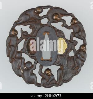 Sword Guard (Tsuba) Depicting Group of Monkeys in a Peach Tree (猿猴摘桃透鐔) ca. 1615–1868 Japanese This tsuba shows a group of eight monkeys in and around a peach tree, with one monkey actually holding a peach in his hand. The faces of each of the monkeys are inlaid in copper. Both hitsu-ana (openings for scabbard accessories) have been plugged with gilt copper plugs of which one has come off. Monkeys fetching peaches is a common subject in Chinese and Japanese art. A Chinese legend has it that Su Wukong (Japanese: Son Gokū, 孫悟空), better known as Monkey King, steals the Peaches of Immortality guar Stock Photo