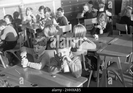 Pupils at South Mead School, Southfield, Wimbledon having their morning milk before play time.. 14th January 1954 Stock Photo