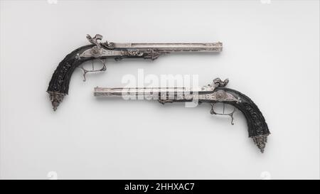 Pair of Percussion Target Pistols Made for Display at the 1844 Exposition des Produits de l'Industrie in Paris dated 1844 Signed by Alfred Gauvain French Created by the celebrated gunsmith Alfred Gauvain (1801–1889) for display at the Exhibition of French Industry in Paris in 1844, these pistols are masterpieces of iron chiseling in the Gothic Revival style. Designed by the sculptor and ornemanist Michel Liénard (1810–1870), they typify the imaginative conception and superb execution of the most elaborate firearms created by Parisian gunmakers to show off their skills at the industrial exhibit Stock Photo