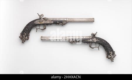 Pair of Percussion Target Pistols Made for Display at the Crystal Palace Exhibition in London, 1851 dated 1851 Signed by Alfred Gauvain French Made by the Parisian gunsmith Alfred Gauvain (1801–1889) for display at the Great Exhibition of the Industry of All Nations in London in 1851, these pistols are masterpieces of iron chiseling in the Renaissance Revival style that was popular in mid-nineteenth-century design. Designed by the sculptor and ornemanist Michel Liénard (1810–1870), they were praised at the time as works of modern art that rivaled in beauty of execution many older firearms pres Stock Photo