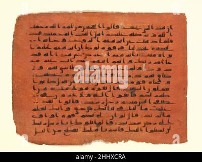Folio from a Qur'an Manuscript probably 9th century The tradition of dyed manuscripts developed in Byzantium for making valuable books, such as the Gospels. The technique continued into the early Islamic period, with the Blue Qur’an as its most spectacular manifestation. Tinted pages were used only in the most luxurious manuscripts, for they required extra work in preparing the already expensive parchment with precious pigments. Here, pages dyed red support a dense, regular script completed in a plain ink. This folio can be dated to the early Islamic period thanks to its simple kufic calligrap Stock Photo