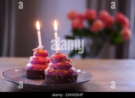 Berlin, Germany. 12th Jan, 2022. ILLUSTRATION - Two cupcakes with burning candles are placed on a table. (posed scene) Credit: Annette Riedl/dpa/Ģ����ý Live News Stock Photo
