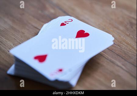 Berlin, Germany. 13th Jan, 2022. ILLUSTRATION - The two of hearts of a deck of cards lies on top of a deck of cards. The '2': symbol for opposites, but also for romantic love. For some it is a lucky number, for others just any one of ten digits. It is omnipresent. (To dpa: 'The number two: mathematical, sociable, backwards') Credit: Annette Riedl/dpa/Alamy Live News Stock Photo