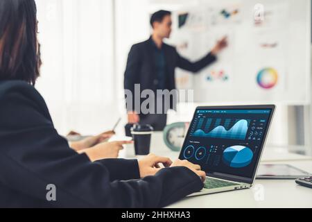 Businesswoman in business meeting using laptop computer proficiently at office for marketing data analysis . Corporate business team collaboration Stock Photo