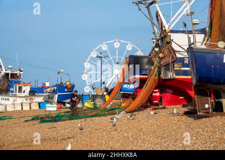 Hastings fisherman sorting nets, on the Old Town Stade, Fishermen's Beach, East Sussex, UK Stock Photo