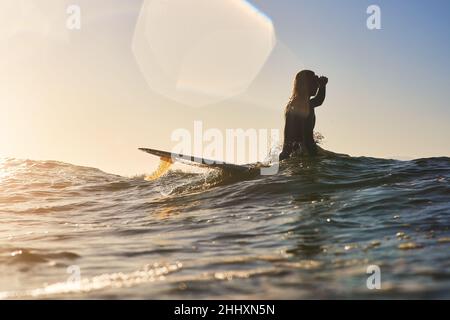 Living life on the deep side. Shot of a handsome young man surfing at the beach. Stock Photo