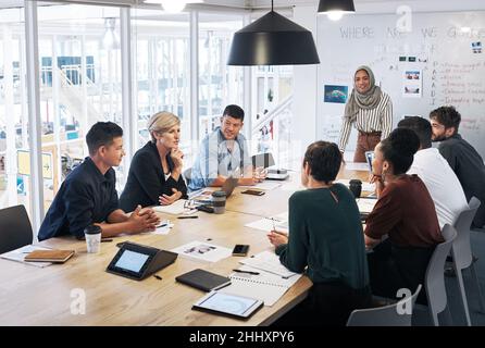 Talking it out around the boardroom table Stock Photo