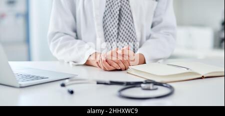 Hands on in keeping you healthy. Cropped shot of an unrecognizable doctor working at her desk. Stock Photo