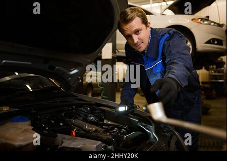 Professional mechanic, Caucasian man in overall work uniform examining  tuning, fixing, repairing car engine, vehicle parts using tools equipment  in wo Stock Photo - Alamy