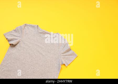 Gray t-shirt with space for print on yellow background Stock Photo