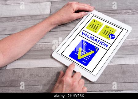 Validation concept shown on a tablet used by a woman Stock Photo