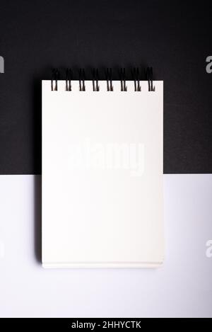 Spiral binder notebook mock up on black and white background. concept decision making pros and cons . Stock Photo