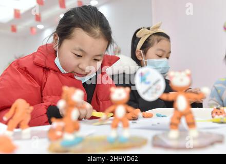 Hefei, Hefei, China. 26th Jan, 2022. On January 26, 2022, in wuliguai community, Dayang Town, Luyang District, Hefei City, Anhui Province, primary school students made the ''cute tiger'' of the Winter Olympic Games with clay under the guidance of their teachers. The 2022 Beijing Winter Olympics coincided with the Spring Festival of the year of the tiger in the Chinese lunar calendar. In order to welcome the arrival of the Winter Olympics, the Party committee, women's Federation and family planning of wuliguai community, Dayang Town, Luyang District, Hefei jointly carried out the activity of Stock Photo