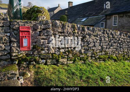 A post box built into a dry stone wall in the Peak District village of Chelmorton, Derbyshire Stock Photo