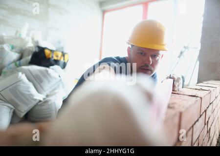 Concentrated male builder measure distance with level equipment Stock Photo