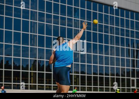 back male athlete shot put at competition Stock Photo