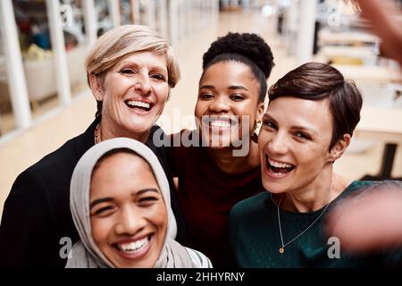 Big smiles from the most diverse and determined team Stock Photo
