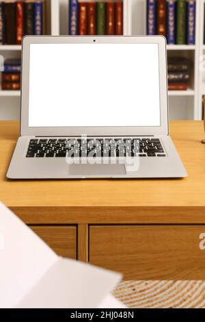 Laptop with blank screen on desk in office Stock Photo
