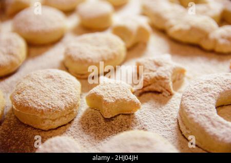 Homemade Creamy oil cookies on a baking sheet sprinkled sugar powder Stock Photo