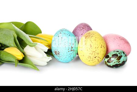 Beautiful Easter eggs and tulips on white background, closeup Stock Photo