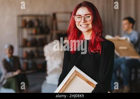 Young student woman smiling at camera during class in art school indoors Stock Photo