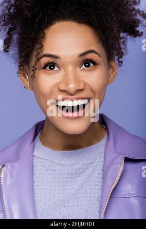 excited young african american woman isolated on purple Stock Photo