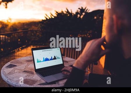 Faceless man working on laptop on terrace Stock Photo
