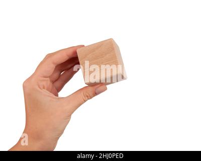 Wooden square cube in hand isolated on the white Stock Photo