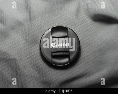 Canon lens cap on grey background Stock Photo