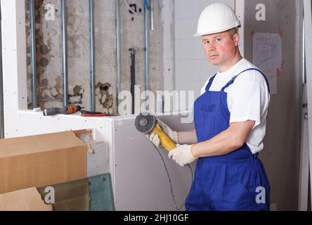 Contractor using angle grinder Stock Photo
